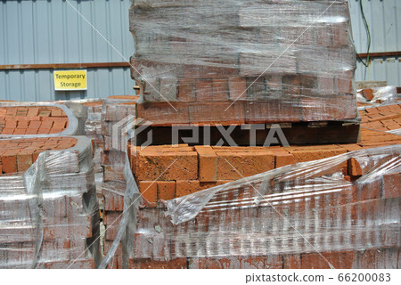 Pile of red clay brick at the construction site.  66200083