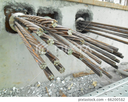 MALACCA, MALAYSIA -APRIL 14, 2016: Pre-stress cable tendons anchor head for pre-stressed concrete at the construction site. It is a technology to get better concrete slab quality with larger span. MALACCA, MALAYSIA -APRIL 14, 2016: Pre-stress cable tendons anchor head for pre-stressed concrete at the construction site. It is a technology to get better concrete slab quality with larger span. 66200582