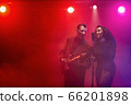 A jazz singer and guitarist perform on stage. 66201898