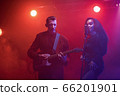 A jazz singer and guitarist perform on stage. 66201901