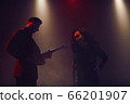 A jazz singer and guitarist perform on stage. 66201907