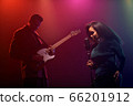 A jazz singer and guitarist perform on stage. 66201912