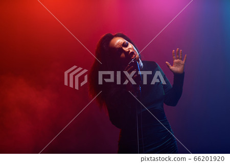 A jazz singer performs on stage. Afro. A jazz singer performs on stage. Afro. 66201920
