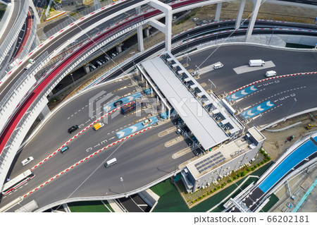 Aerial view of a car passing through a toll gate on a highway Aerial view of a car passing through a toll gate on a highway 66202181