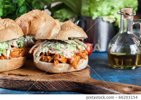 Pulled chicken sandwich with salad and bbq sauce Pulled chicken sandwich with salad and bbq sauce 66203154