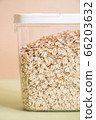 Plastic transparent container with oatmeal on a green background. 66203632
