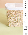 Plastic transparent container with oatmeal on a green background. 66203634