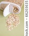 Plastic transparent container with oatmeal on a green background. 66203635