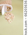 Plastic transparent container with oatmeal on a green background. 66203636
