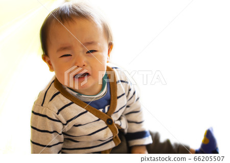 Baby sitting and crying Child complaining about something 66205507