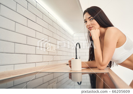 Smiling Babe Woman Bending Over The Kitchen Stock Photo PIXTA