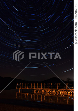 Ullswater Star Trail. Star trails above an Ullswater pier, a lake in the English Lake District. Ullswater Star Trail. Star trails above an Ullswater pier, a lake in the English Lake District. 66206169