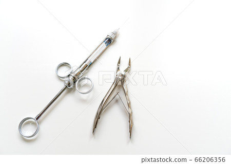 Dental instruments on a white background, syringe 66206356