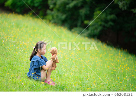 Girl sitting with a teddy bear Girl sitting with a teddy bear 66208121