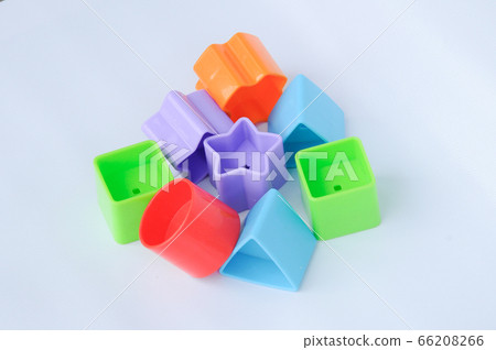 Isolated children's toy blocks in various shapes made of plastic on white background  66208266