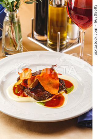 Beef tenderloin medallions with sauce and onion Beef tenderloin medallions with sauce and onion 66208695