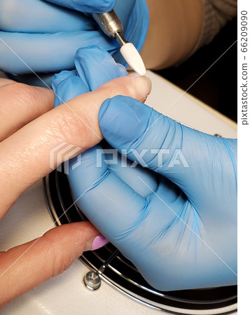 processing of nails with hardware manicure in a beauty salon. 66209090