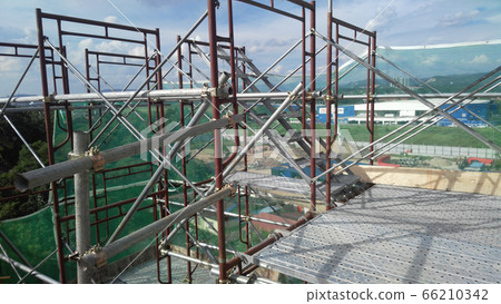 MALACCA, MALAYSIA -SEPTEMBER 23, 2016: Temporary access and staircase supported by reinforced scaffolding at the construction site. Used by construction workers. MALACCA, MALAYSIA -SEPTEMBER 23, 2016: Temporary access and staircase supported by reinforced scaffolding at the construction site. Used by construction workers. 66210342