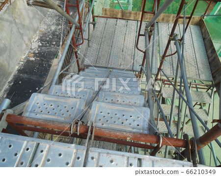 MALACCA, MALAYSIA -SEPTEMBER 23, 2016: Temporary access and staircase supported by reinforced scaffolding at the construction site. Used by construction workers.   66210349