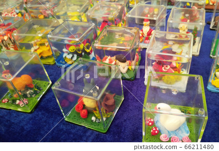 KUALA LUMPUR, MALAYSIA -SEPTEMBER 23, 2016: Miniature models and cartoon characters are made using plastic clay and placed in perspex containers. KUALA LUMPUR, MALAYSIA -SEPTEMBER 23, 2016: Miniature models and cartoon characters are made using plastic clay and placed in perspex containers. 66211480