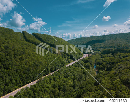 Aerial view of a rural highway between mountains 66211583