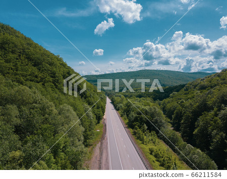 Aerial view of a rural highway between mountains 66211584
