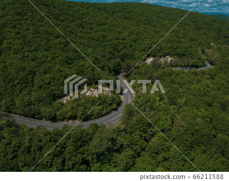 Mountain winding zig zag road. Top aerial view: cars driving on road from above. 66211588