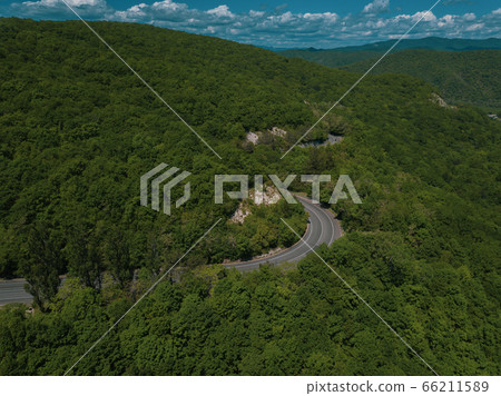 Mountain winding zig zag road. Top aerial view: cars driving on road from above. Mountain winding zig zag road. Top aerial view: cars driving on road from above. 66211589