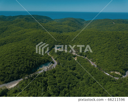 Mountain winding zig zag road. Top aerial view: cars driving on road from above. Mountain winding zig zag road. Top aerial view: cars driving on road from above. 66211596
