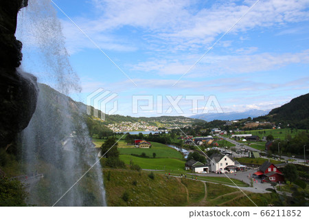 Norway, a private house seen from the Steindahl waterfall, a tourist attraction along the road from Bergen to Hardanger Fjord Norway, a private house seen from the Steindahl waterfall, a tourist attraction along the road from Bergen to Hardanger Fjord 66211852