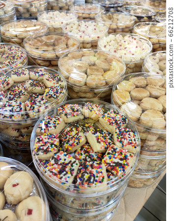 KUALA LUMPUR, MALAYSIA -MAY 17, 2020: The biscuits are sold in transparent plastic containers and are sorted by type and price. Displayed on the table. Special made for Muslim's Eid celebrations. 66212708