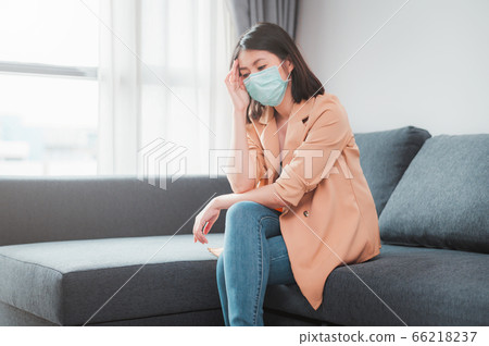 Woman wearing face mask feeling sick Woman wearing face mask feeling sick 66218237