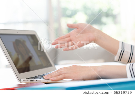 Hands of a woman holding a remote meeting on a computer Hands of a woman holding a remote meeting on a computer 66219759