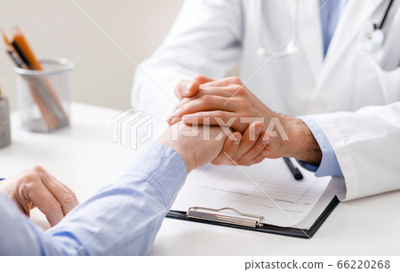 Doctor supporting senior patient at clinic, close up Doctor supporting senior patient at clinic, close up 66220268
