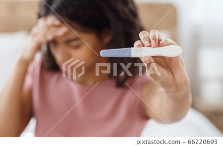 Depressed black lady holding negative pregnancy test Depressed black lady holding negative pregnancy test 66220693