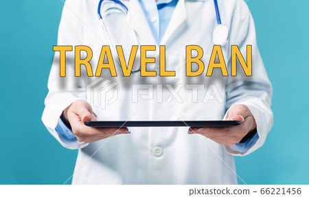 Travel Ban theme with a doctor using a tablet pc 66221456