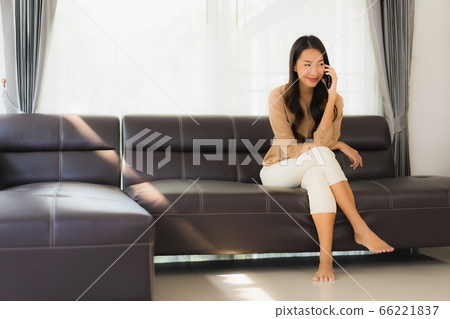 asian business woman work from home with laptop mobile phone with cardboard box ready for shipping asian business woman work from home with laptop mobile phone with cardboard box ready for shipping 66221837