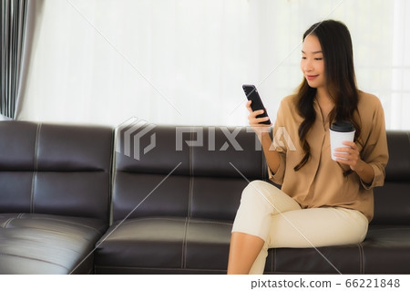 asian business woman work from home with laptop mobile phone with cardboard box ready for shipping asian business woman work from home with laptop mobile phone with cardboard box ready for shipping 66221848