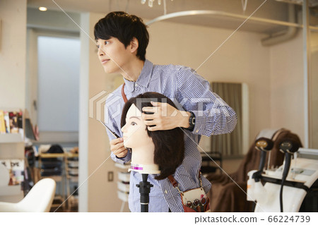 Young man hairdresser hair mannequin assistant Young man hairdresser hair mannequin assistant 66224739