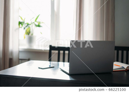 Opened laptop notebook on black table with mobile Opened laptop notebook on black table with mobile 66225100