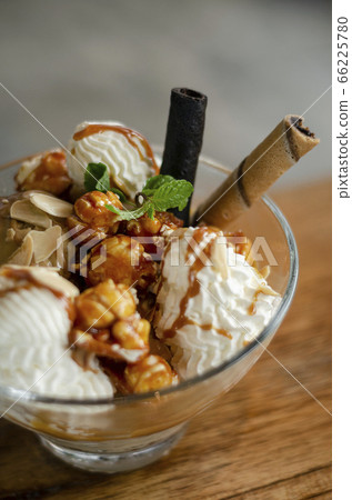caramel and almond ice cream sundae dessert in 66225780