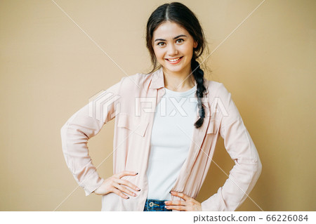 Young friendly smiling brunette girl in casual clothes Young friendly smiling brunette girl in casual clothes 66226084
