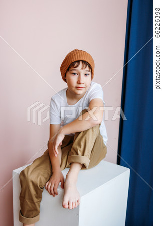 Fashionable attractive tween boy with dark hair in hat Fashionable attractive tween boy with dark hair in hat 66226398