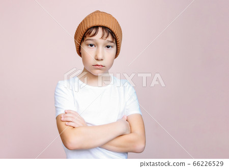Attractive tween unhappy boy with dark hair in hat Attractive tween unhappy boy with dark hair in hat 66226529