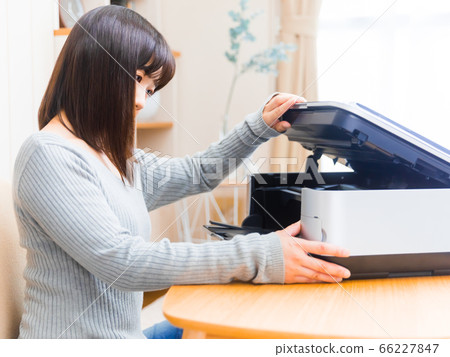 Woman opening the printer Ink exchange trouble Trouble copy space 4:3 Woman opening the printer Ink exchange trouble Trouble copy space 4:3 66227847