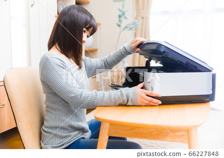 Woman opening the printer Ink exchange Copy space 66227848