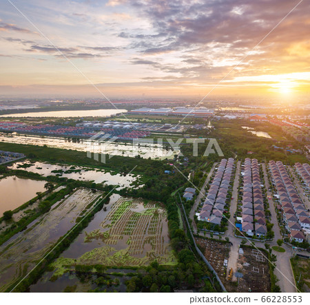 Sunset over city and field Sunset over city and field 66228553