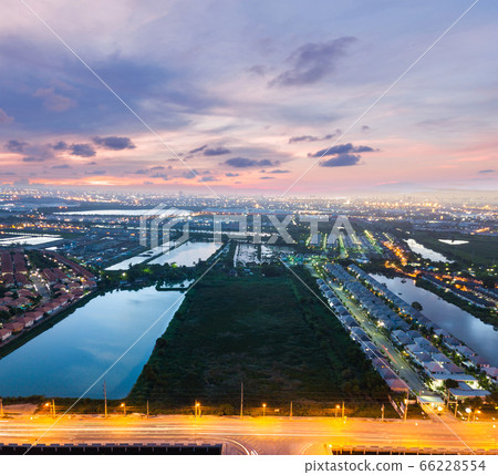 Sunset over city and field Sunset over city and field 66228554