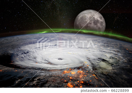 View from space of a giant hurricane over the ocean with full moon rise in background. 66228899