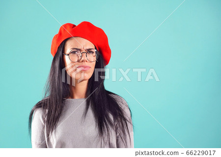 stylish woman in red beret frowned at camera stylish woman in red beret frowned at camera 66229017